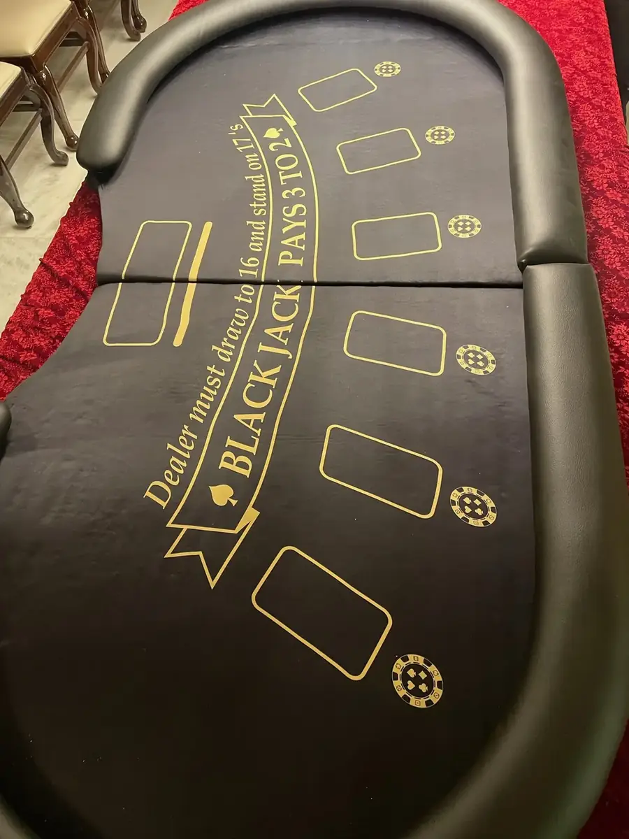 Baazigar blackjack table with gold print on black felt