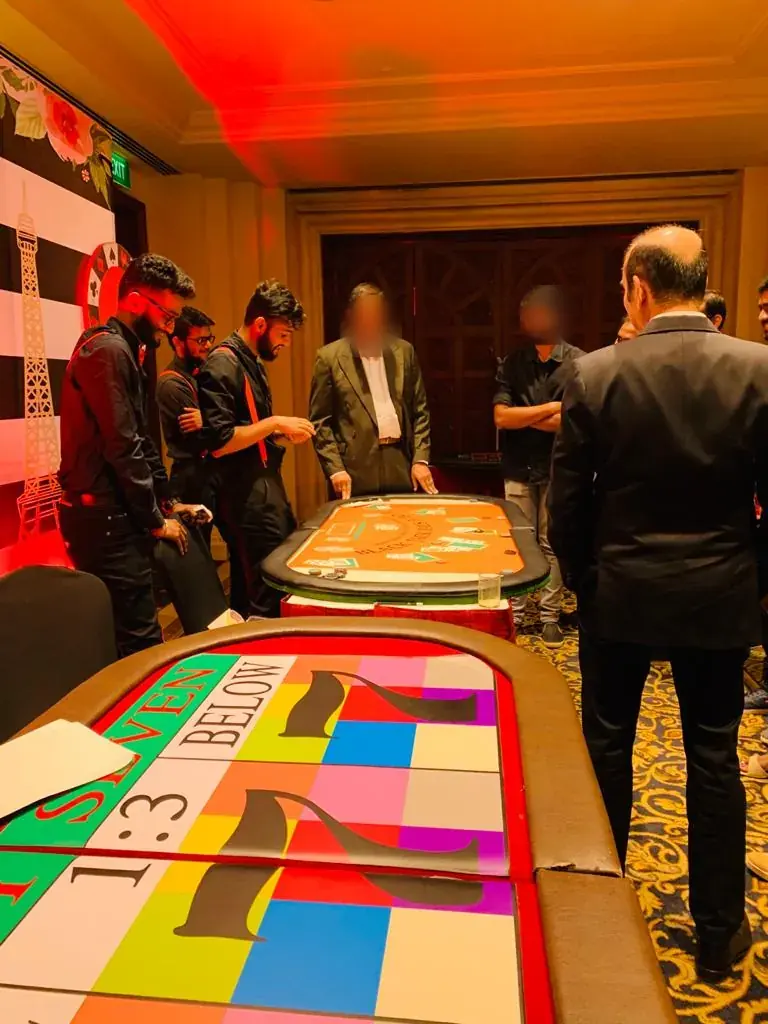 Casino floor with a Lucky 7 table and a blackjack table in play