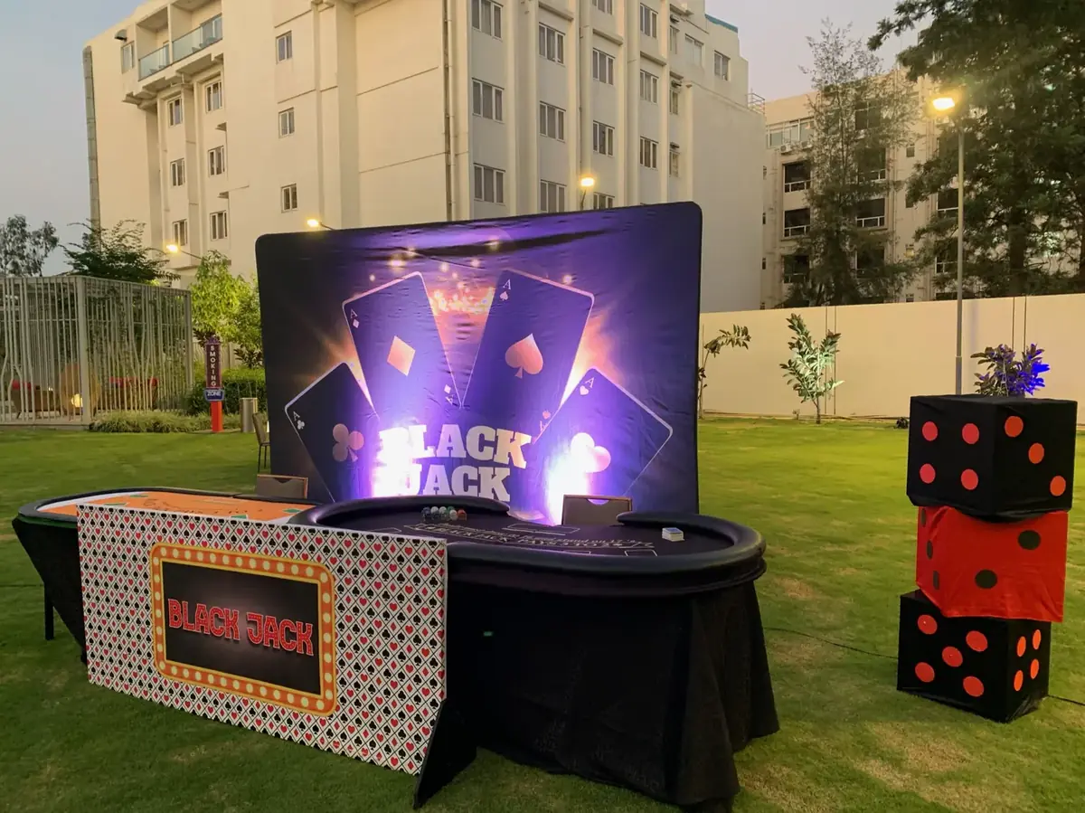 Casino floor on a lawn with roulette and blackjack stations