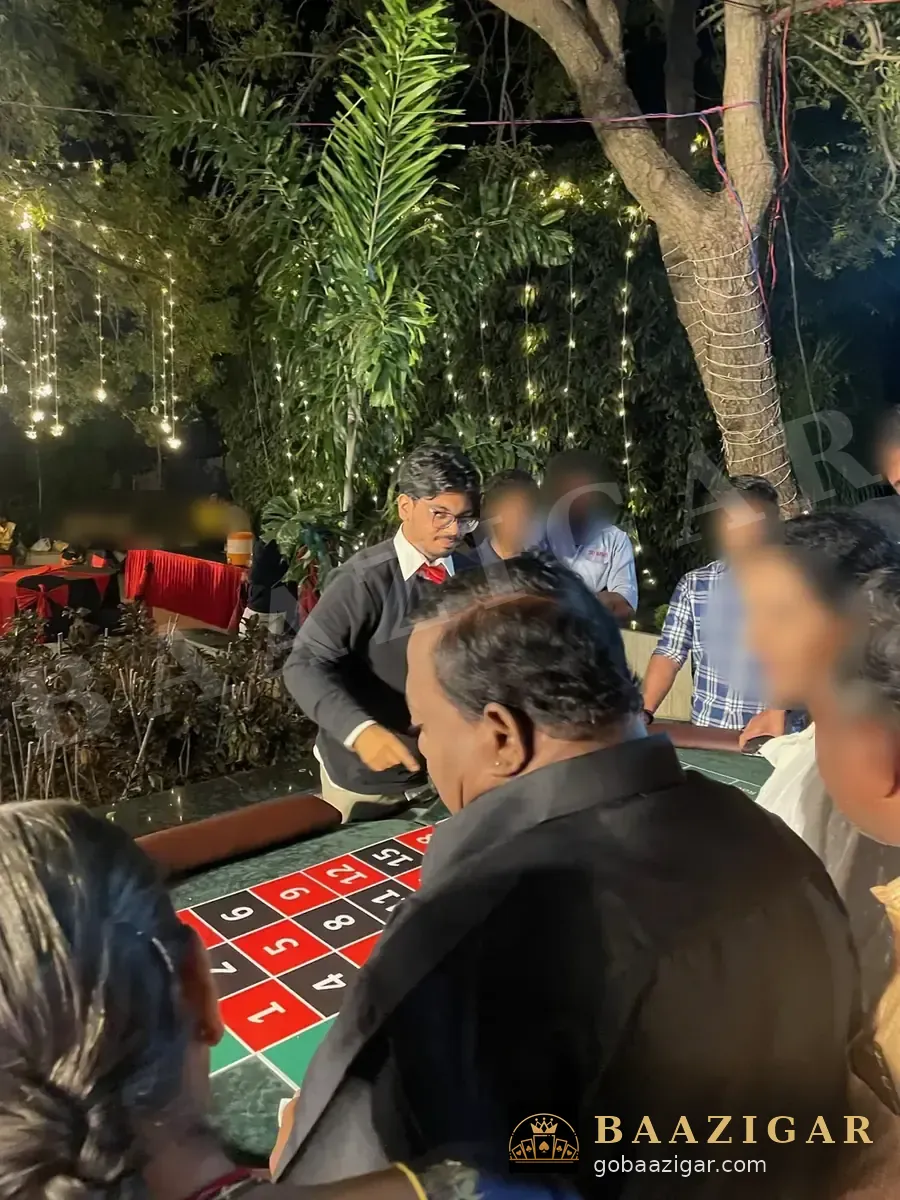 Dealer spinning roulette for a crowd of guests at night