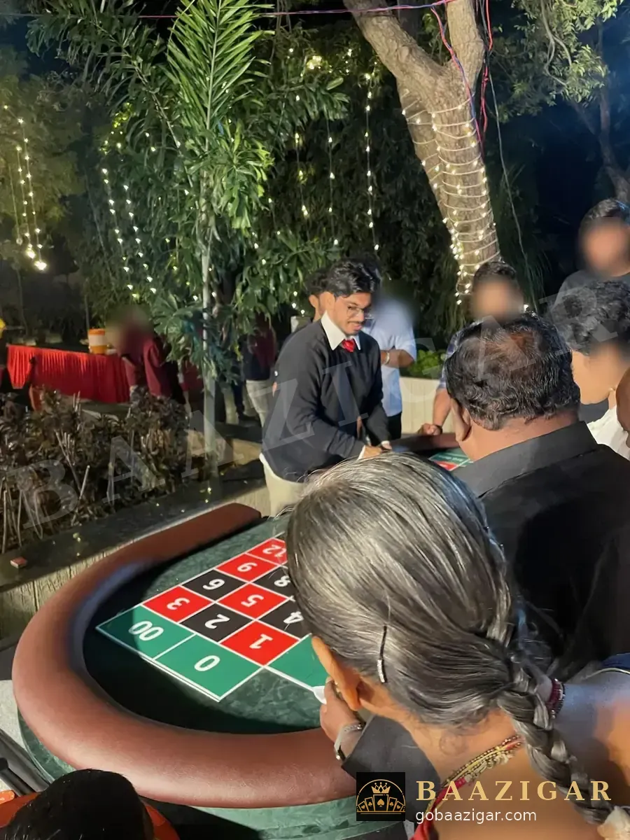 Guests crowd around a Baazigar roulette table at an evening garden party