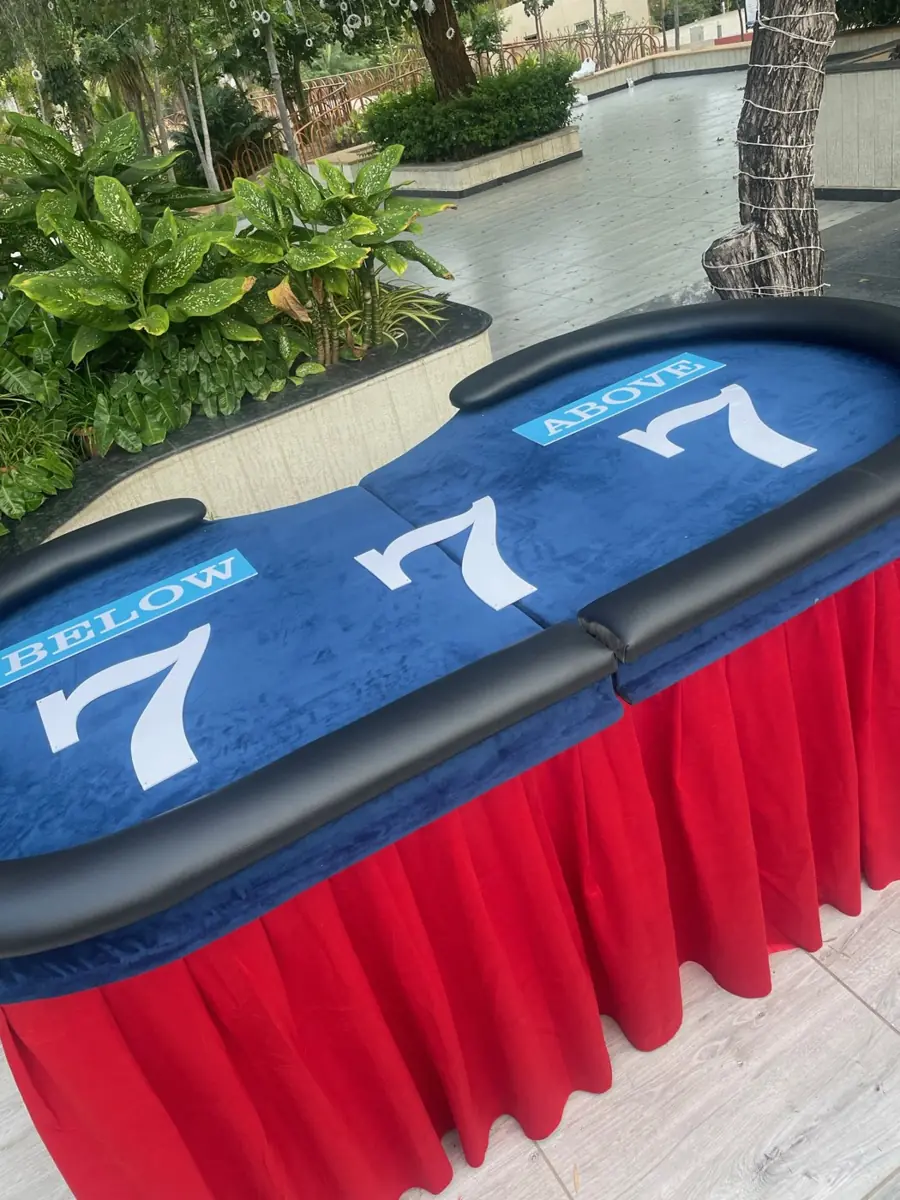 Lucky 7 table with red skirting in a garden