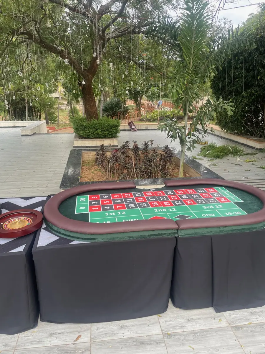 Roulette table set up by a garden pool