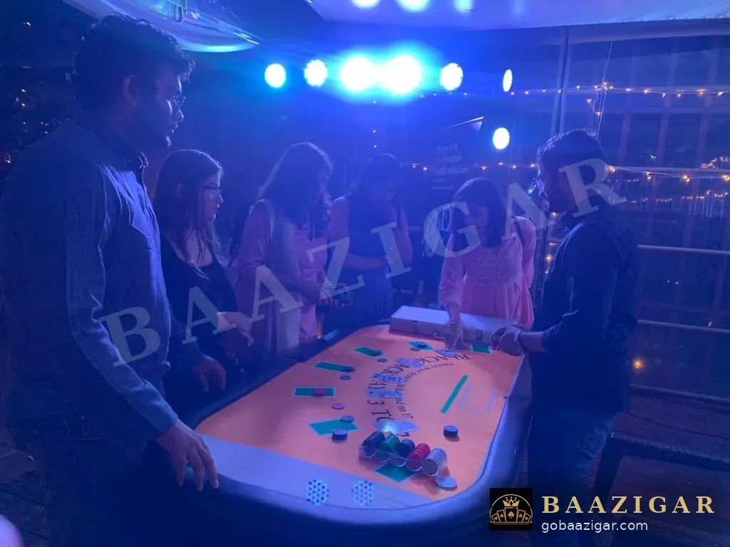 Guests at a blackjack table under party lights