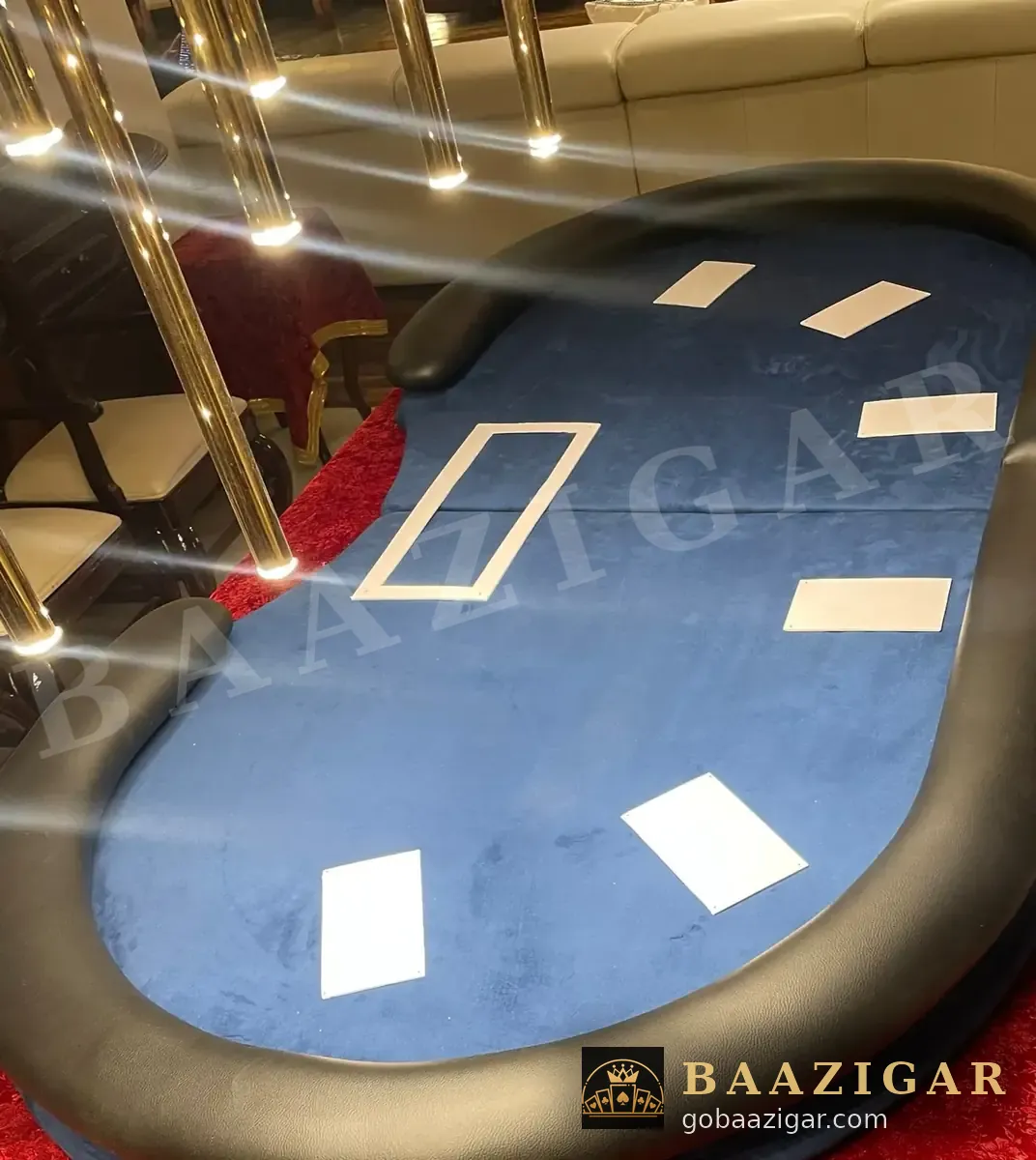 Blue poker table with padded rail under warm lights