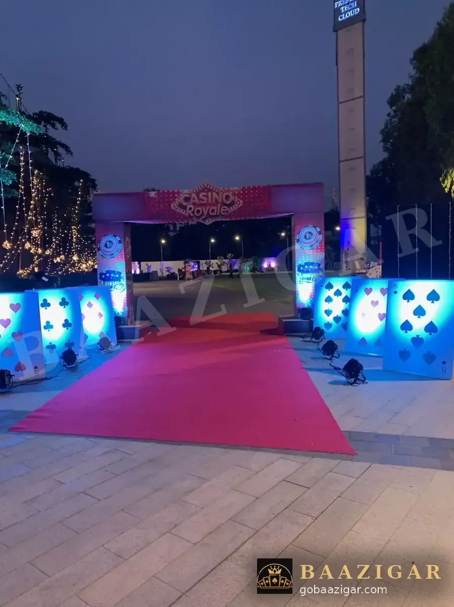 Red-carpet walkway lined with glowing card-suit panels