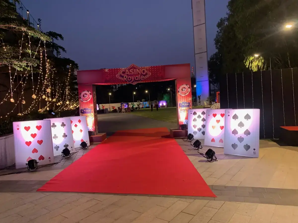 Red-carpet casino entrance with light-up card panels