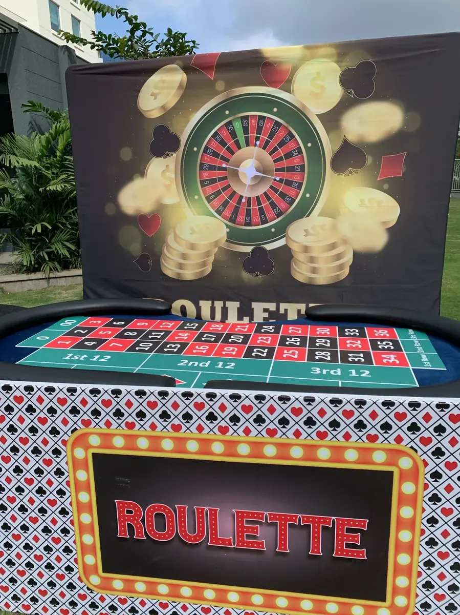 Roulette station with themed backdrop and table skirting on a lawn