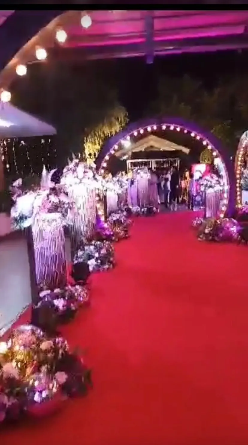 Floral walkway with a casino arch at a wedding