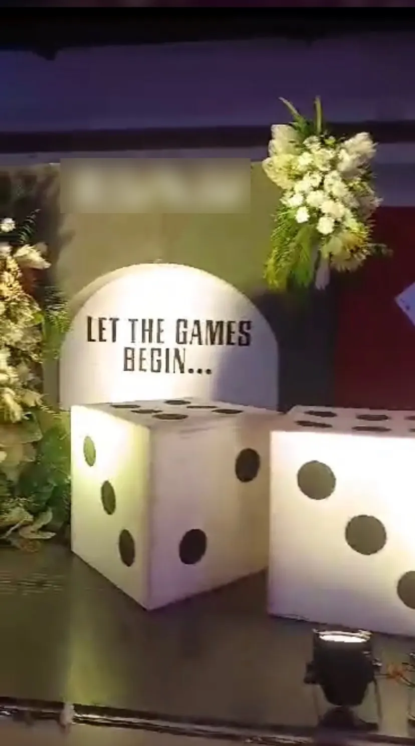 Let the games begin sign with giant dice at a wedding