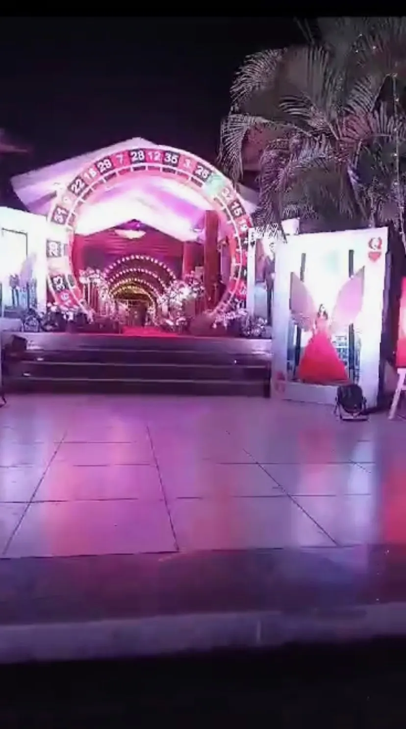 Casino-themed wedding stage with a roulette arch