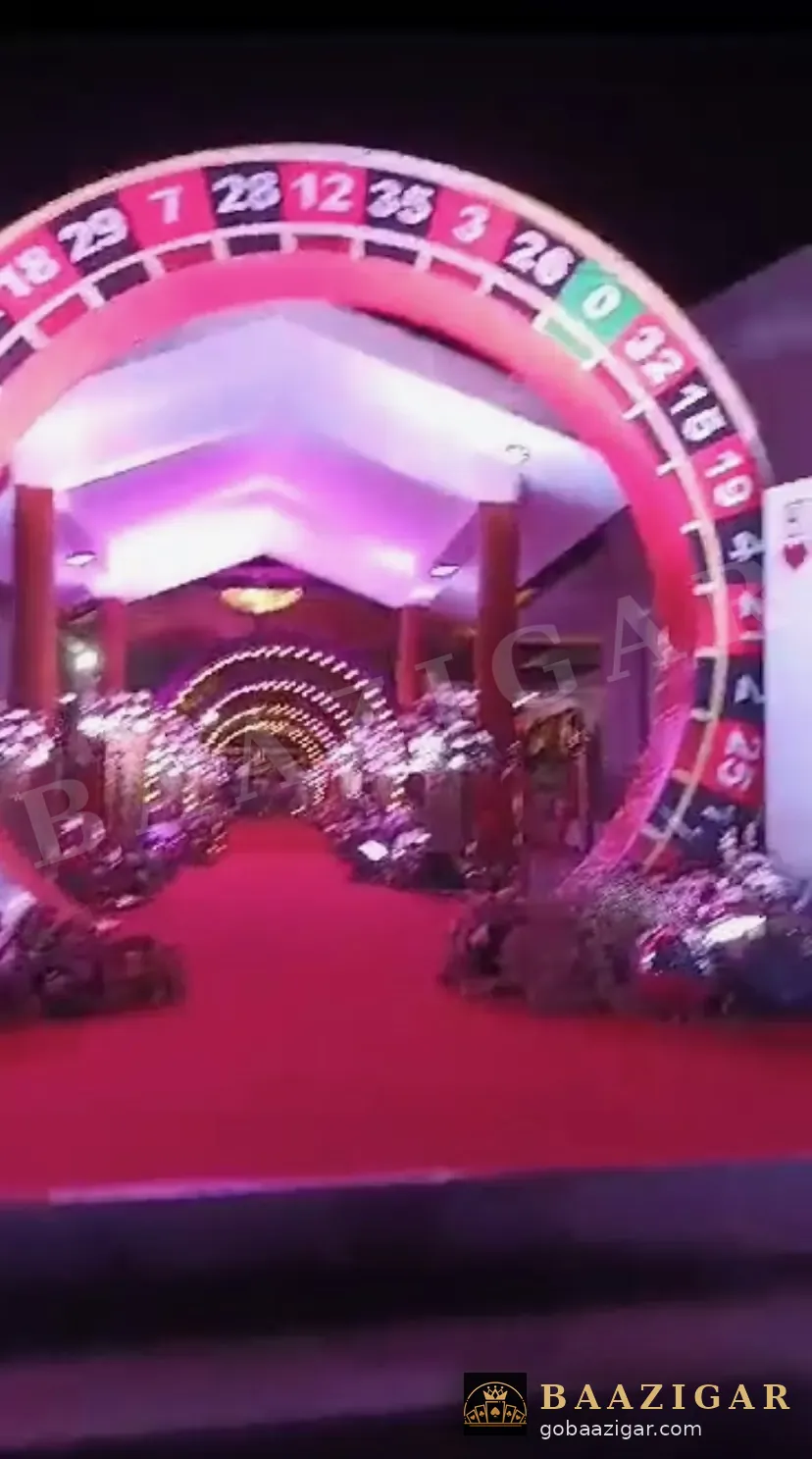 Roulette-wheel arch over a red-carpet wedding entrance